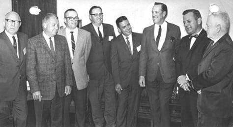 Presidents meet with Claude Rogers, director of the State fishing tournament and Virginia Delegate Richard Bagley. From left to right are past presidents Claude E. Barfield, C. J. Bradley, J. C. Robinson, Earl C. Bigger, then current president Harry R. Livers, Jr., Claude Rogers, Richard Bagley, and past president George Robertson.